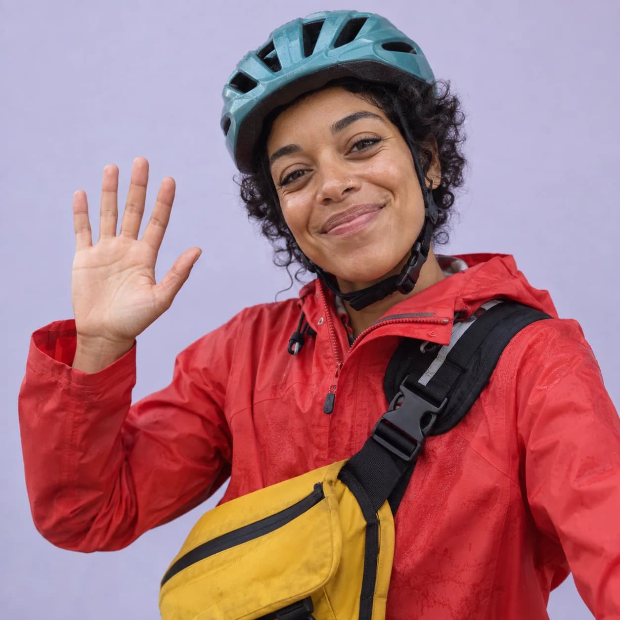 Prepared photoreal portrait reference of Nia in a red raincoat and teal bike helmet.