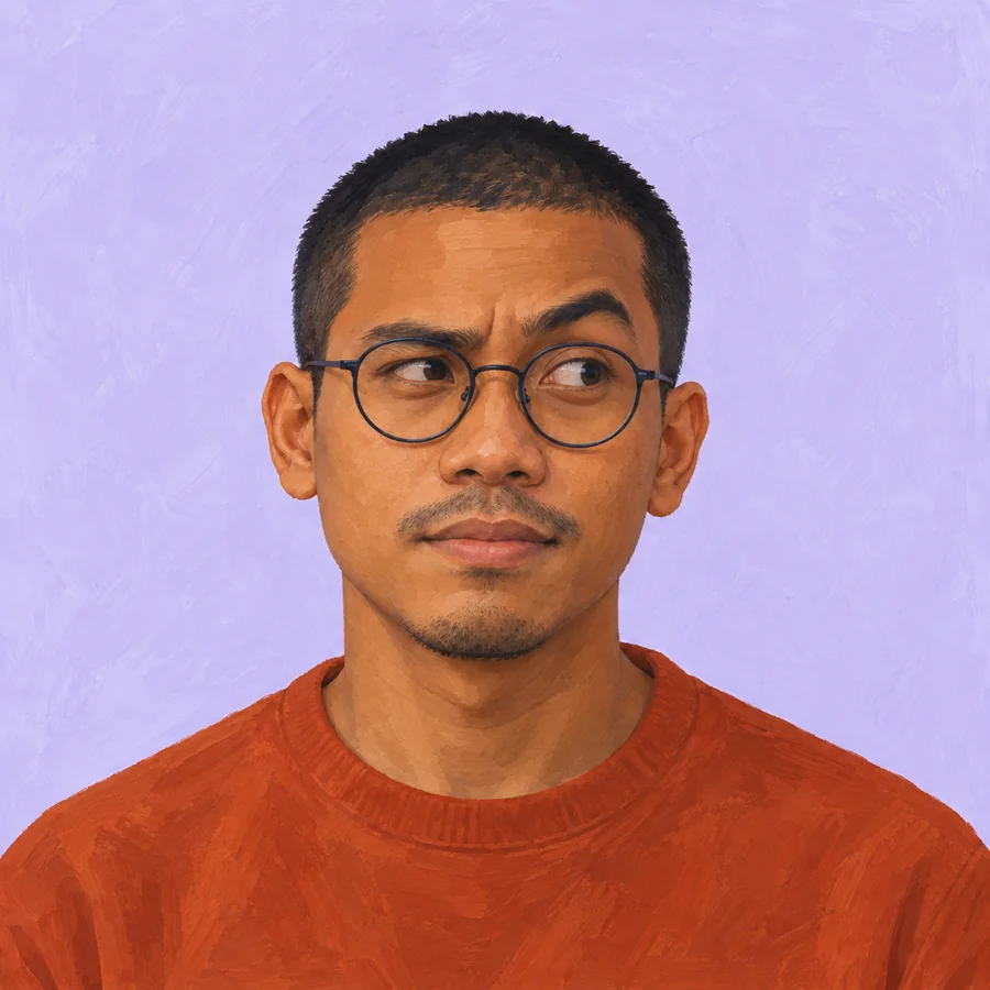 The same glasses-wearing man with a thoughtful raised-brow expression and unchanged orange crewneck