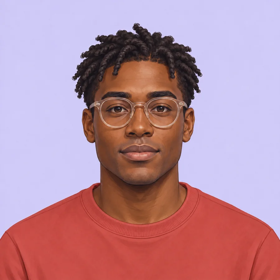 The same man with short twists and translucent glasses with his crewneck changed to deep coral